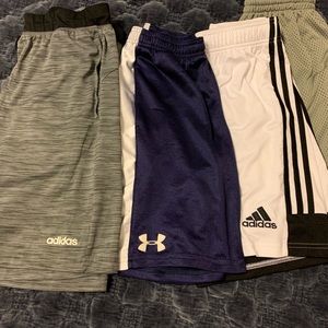 Adidas and under Armour lot, 4 pairs of youth medium athletic shorts.